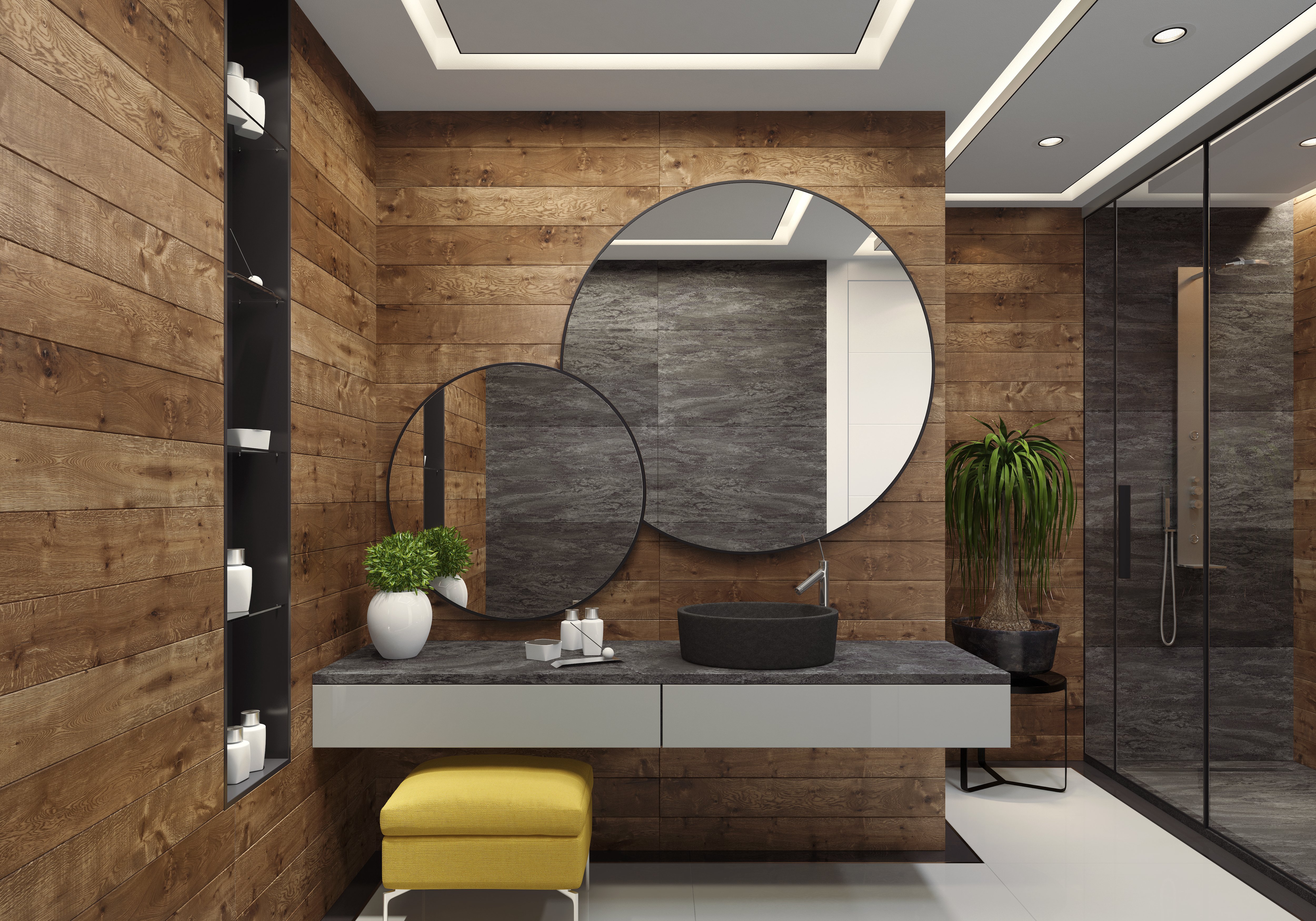 Luxury modern bathroom with full wood shiplap walls, two large round mirrors, gray stone vanity, and yellow stool